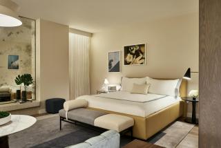 a hotel room with a bed and a mirror