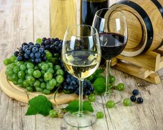 a glass of wine sitting on top of a wooden table
