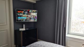 a screen shot of a bedroom next to a window