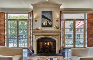 a fireplace in a living room filled with furniture and a fire place