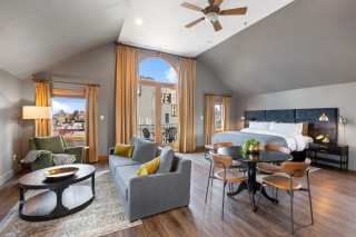 a living room filled with furniture and a large window