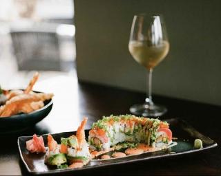 a plate of food and a glass of wine