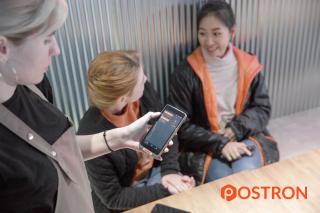 a group of people looking at a phone