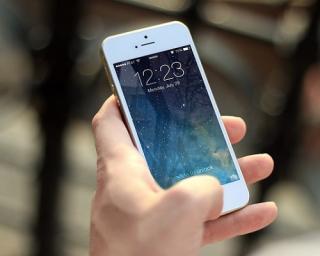 a hand holding a cell phone