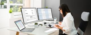 a person sitting at a table using a laptop