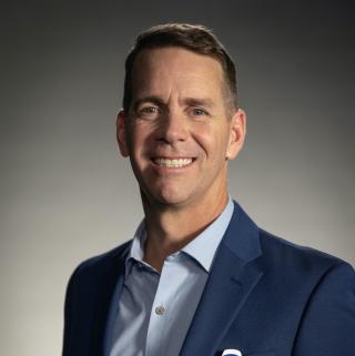 John Padgett wearing a suit and tie