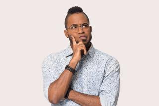 a man wearing glasses talking on a cell phone
