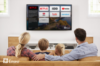 Family watching hotel TV