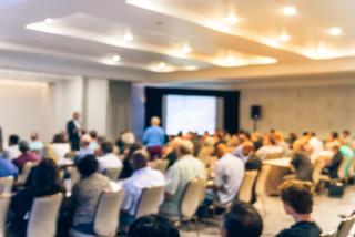a group of people in a hotel conference room