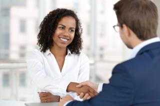woman shaking hands with hiring manager
