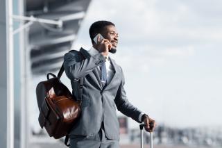 a man wearing a suit and tie talking on a cell phone