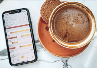 enviivo mobile app next to cup of coffee