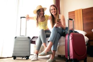 two happy women with their luggage getting ready to travel