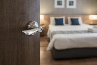 hotel room door and bed shutterstock