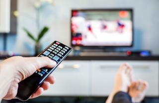a hand holding a remote control shutterstock