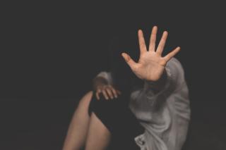 a woman with hand raised to say stop