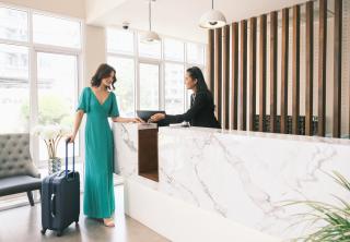 Woman checking in at hotel front desk