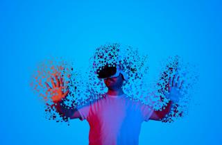 human disappearing into a pixelated metaverse environment