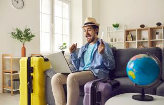 man booking travel via laptop