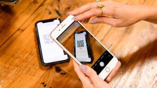 a hand holding a cell phone with Go Tab