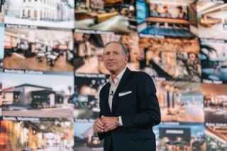 Howard Schultz standing in front of a building