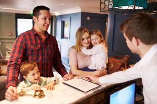 Family check-in at hotel front desk
