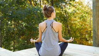 woman meditating within nature