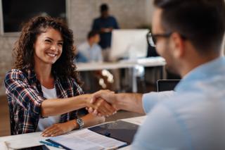 woman shaking a manager's hand