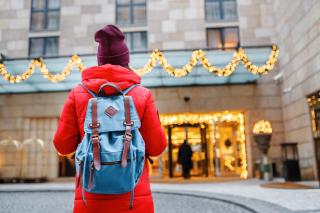 a person standing in front of a hotel at christmas