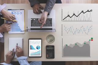business people in a forecasting meeting with data charts
