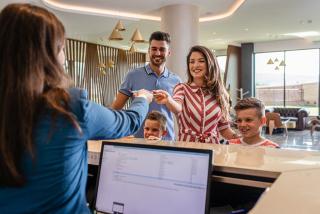 a family checking in at a hotel