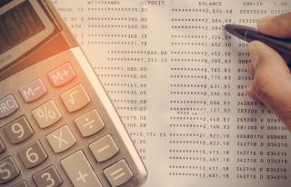 calculator and invoices that need to be paid