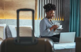 woman on her phone in a hotel room