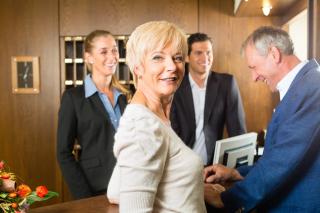 hotel guests checking in at front desk