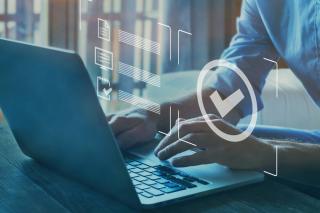 person on a laptop with digital checkmark overlay