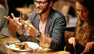hipster guy with man bun drinking wine