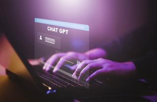 laptop screen showing a person using chat gpt