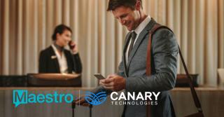 front desk agent and person checking in on phone