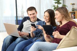 teenagers using multiple mobile devices