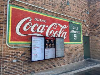 digital menu board on a brick wall