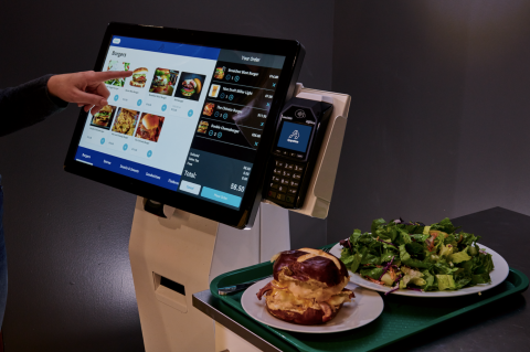 a laptop computer sitting on top of a plate of food