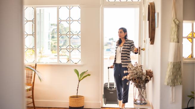 woman entering a rental using smart lock technology