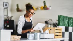 generic cashier gal standing at pos with payment